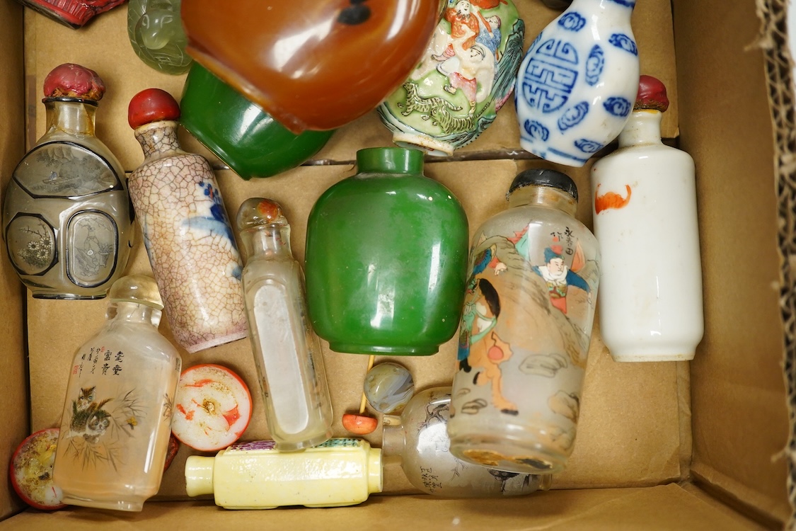 A small collection of Chinese snuff bottles, 19th century and later to include reverse glass painted examples and cinnabar lacquered examples, largest 9.5cm high